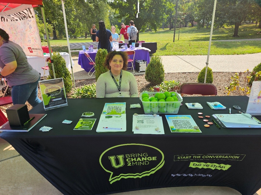 Salem Melchor, student leader with U Bring Change 2 Mind, sits at the organization’s booth during the Mental Health Resource Fair on Sept. 17 at IUS.